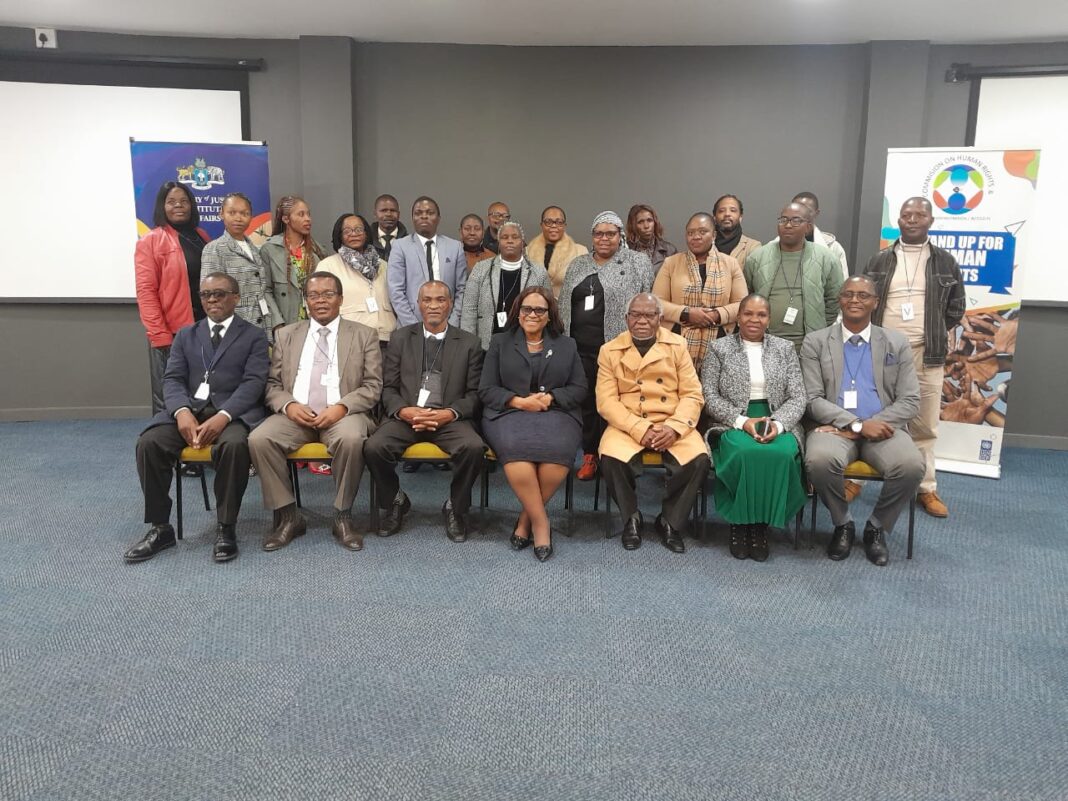 The Human Rights Commision membrs pose for a group photo with senior governemtn officials after the workshop.