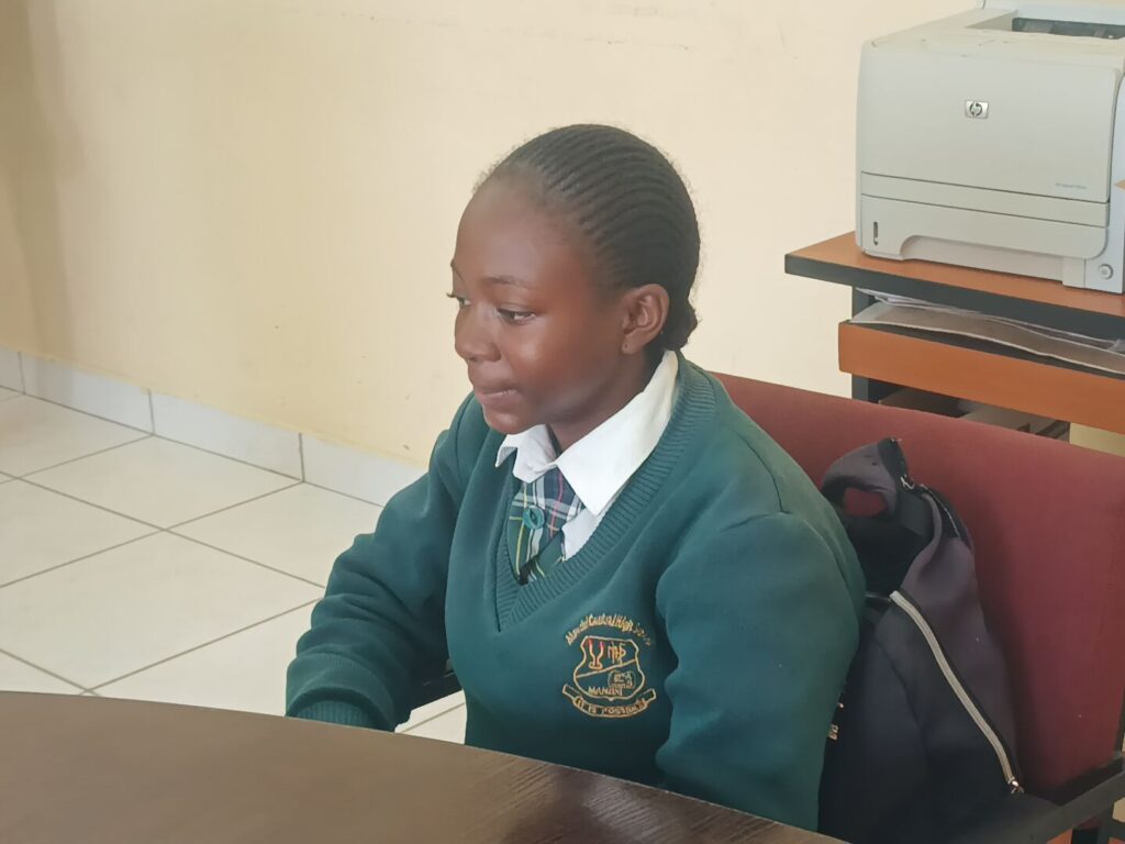 Sanelisiwe Mphaphu seated in readiness to write her English paper I examination. (r) Sanelisiwe Mphaphu in full sprint to finish her race.