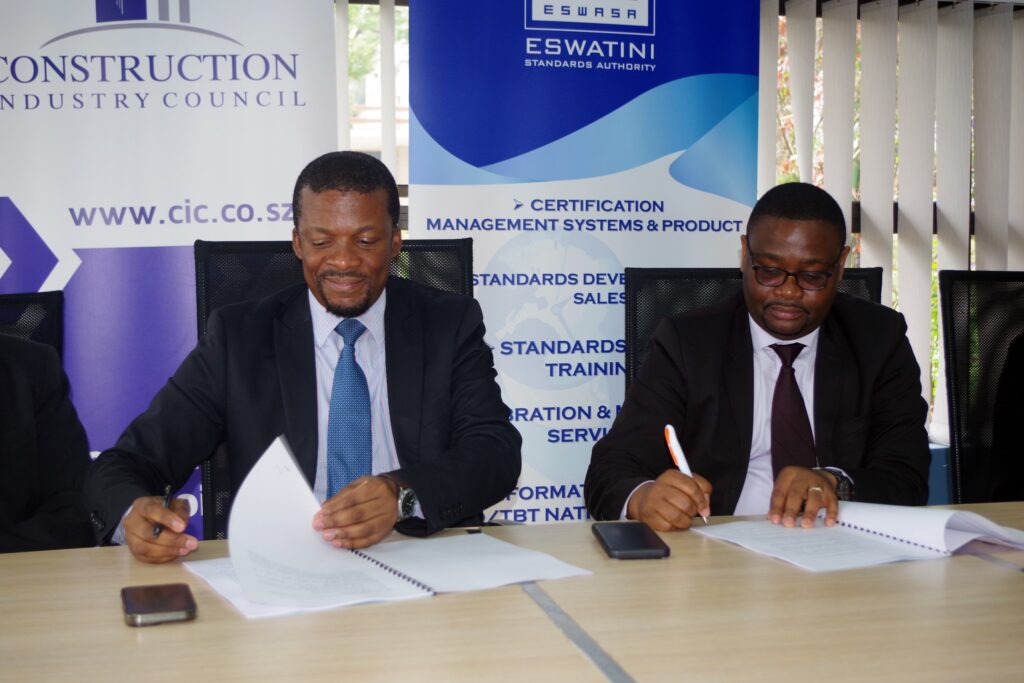 CIC CEO Maqhawe Mnisi with Eswatini Standards Authority CEO Ncamiso Mhlanga after signing the Memorandum of Understanding to strengthen relations at the CIC Head Office yesterday. (Below) Mnisi and Mhlanga sign the MoU.