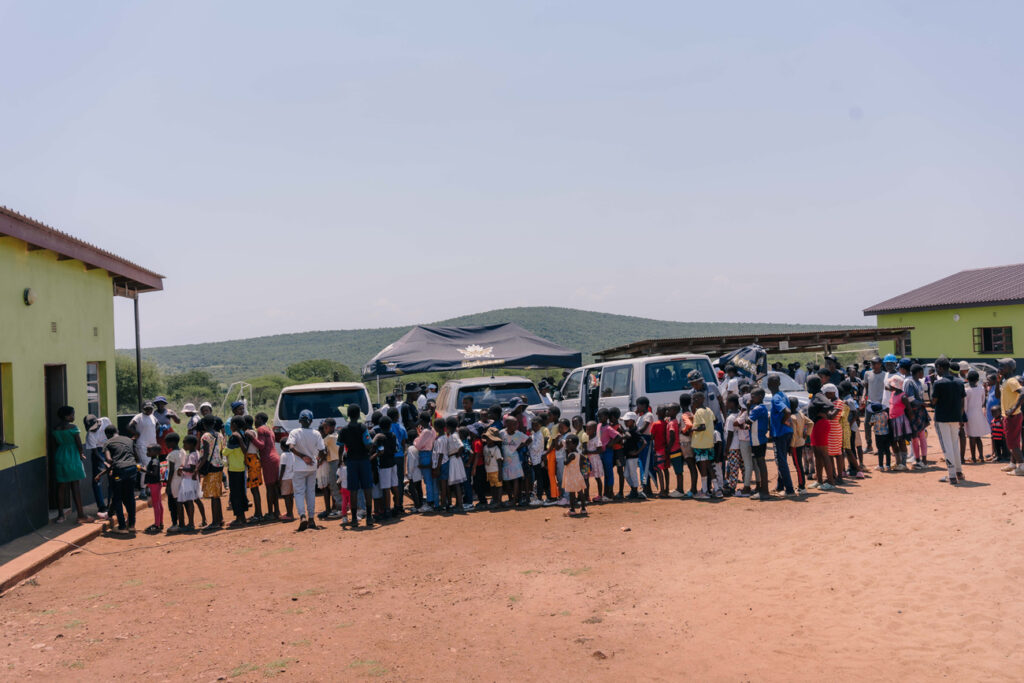 The 8bet team Some of the 320 children lining up to receive Christmas lunch from the company.