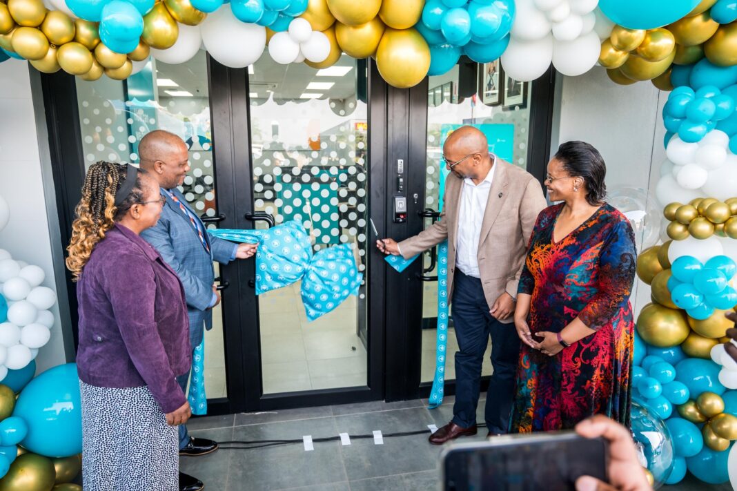 FNB Eswatini CEO Thokozani Dlamini cutting the ribbon to mark the official opening of the bank’s new branch at Siphofaneni.