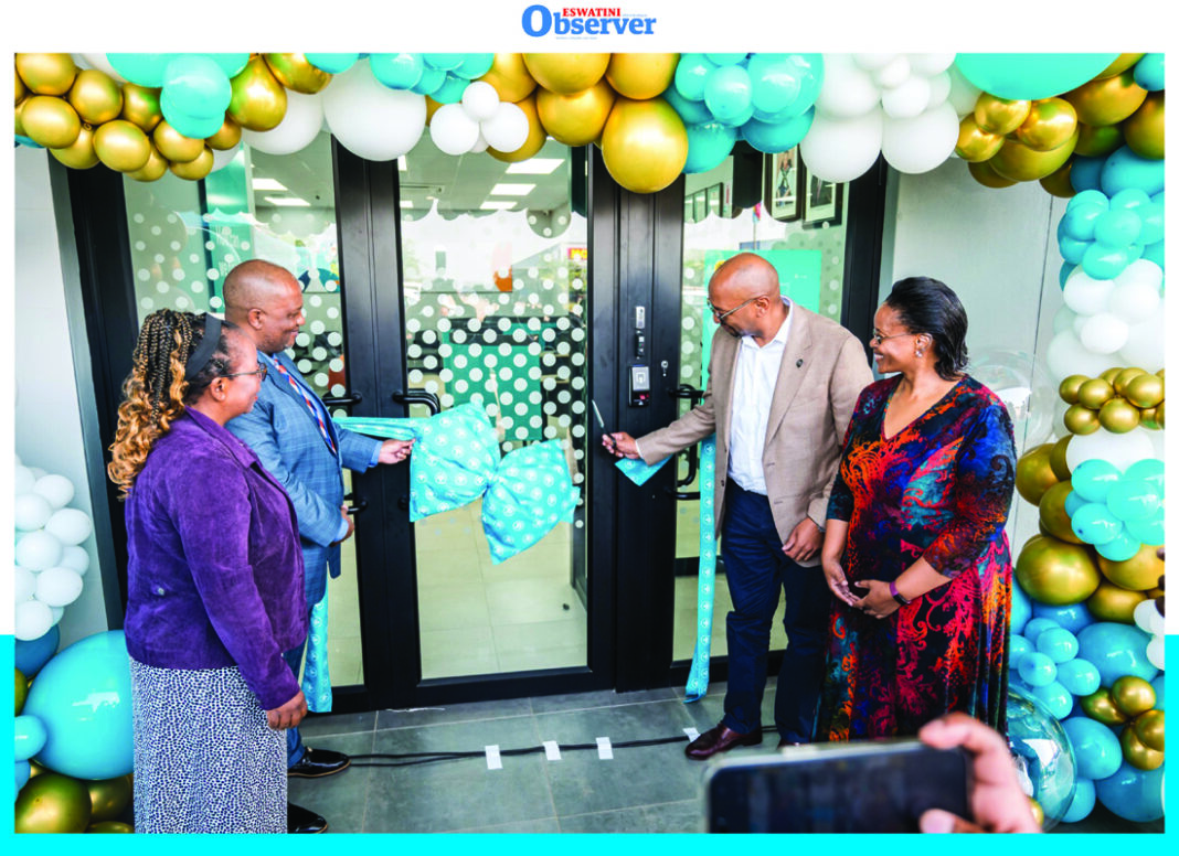 FNB FNB Eswatini CEO Thokozani Dlamini cutting the ribbon to mark the official opening of the bank’s new branch at Siphofaneni.