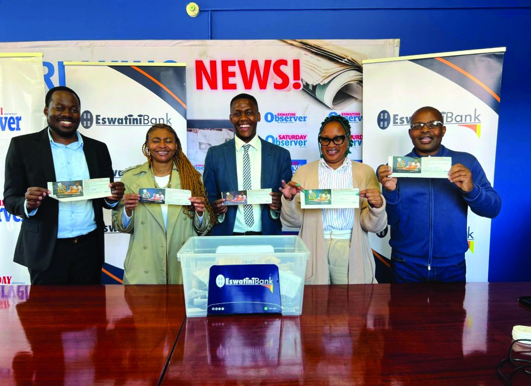 EswatiniBank EswatiniBank Marketing Officer Sakhile Simelane, flanked by Eswatini Observer’s Nhlanhla Ngwenya, Nqobile Simelane, Nonjabulo Mabunda and Nelson Fakudze, display the winning entries during the EswatiniBank ‘Transact Nomakuphi’ draw held at the Eswatini Observer offices yesterday.