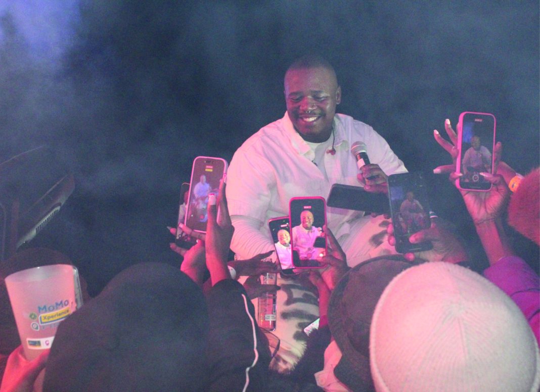 South African singer Lloyiso engages closely with fans during his MoMo Xperience set, sharing moments and stories.
