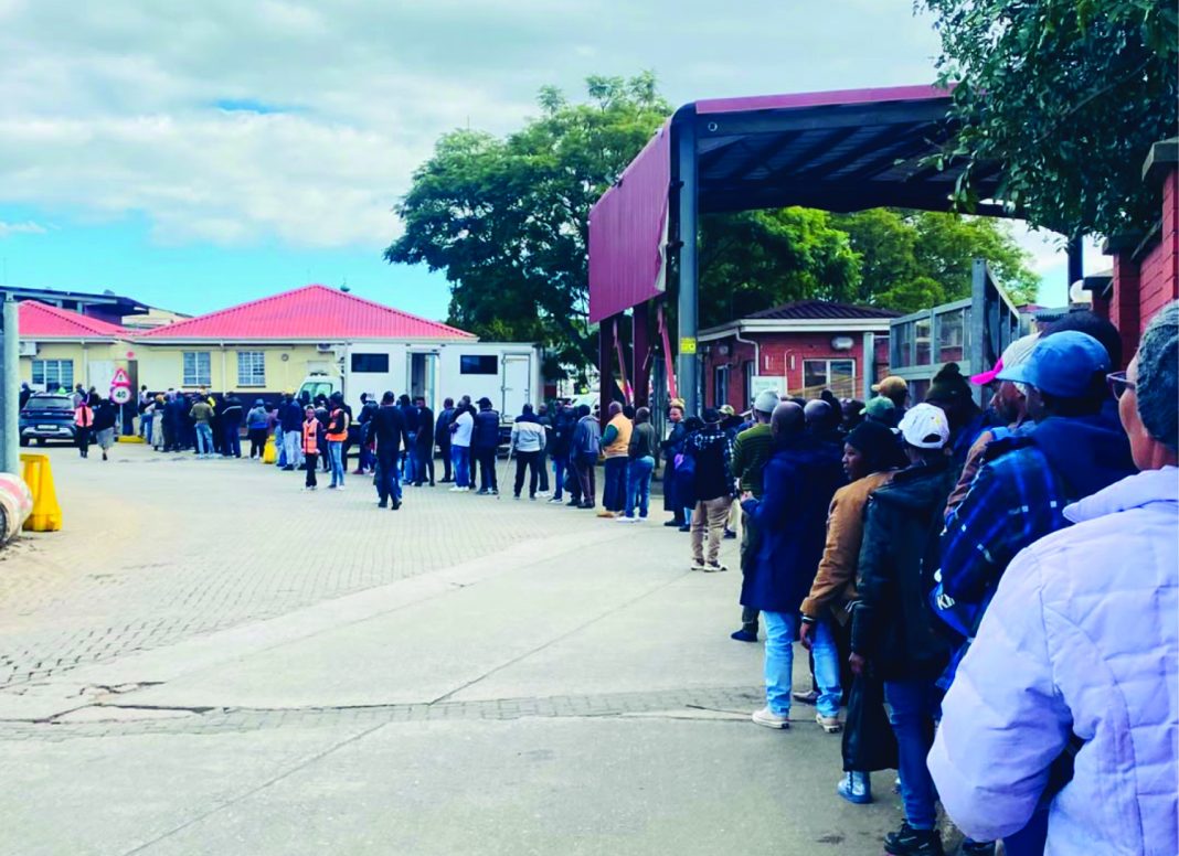 Some of the tourists queuing for their passports to be stamped.