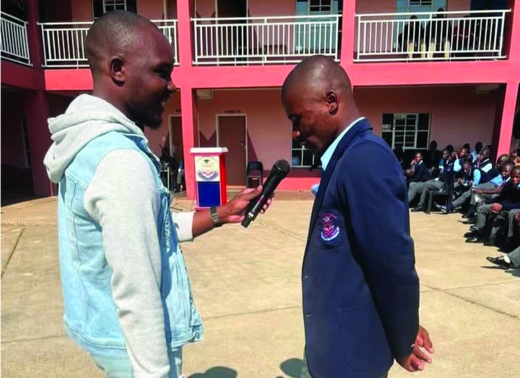 Vulamasango Mzwandile Mtsetfwa interacting with a student at Vulamasango. (Courtesy Pic)